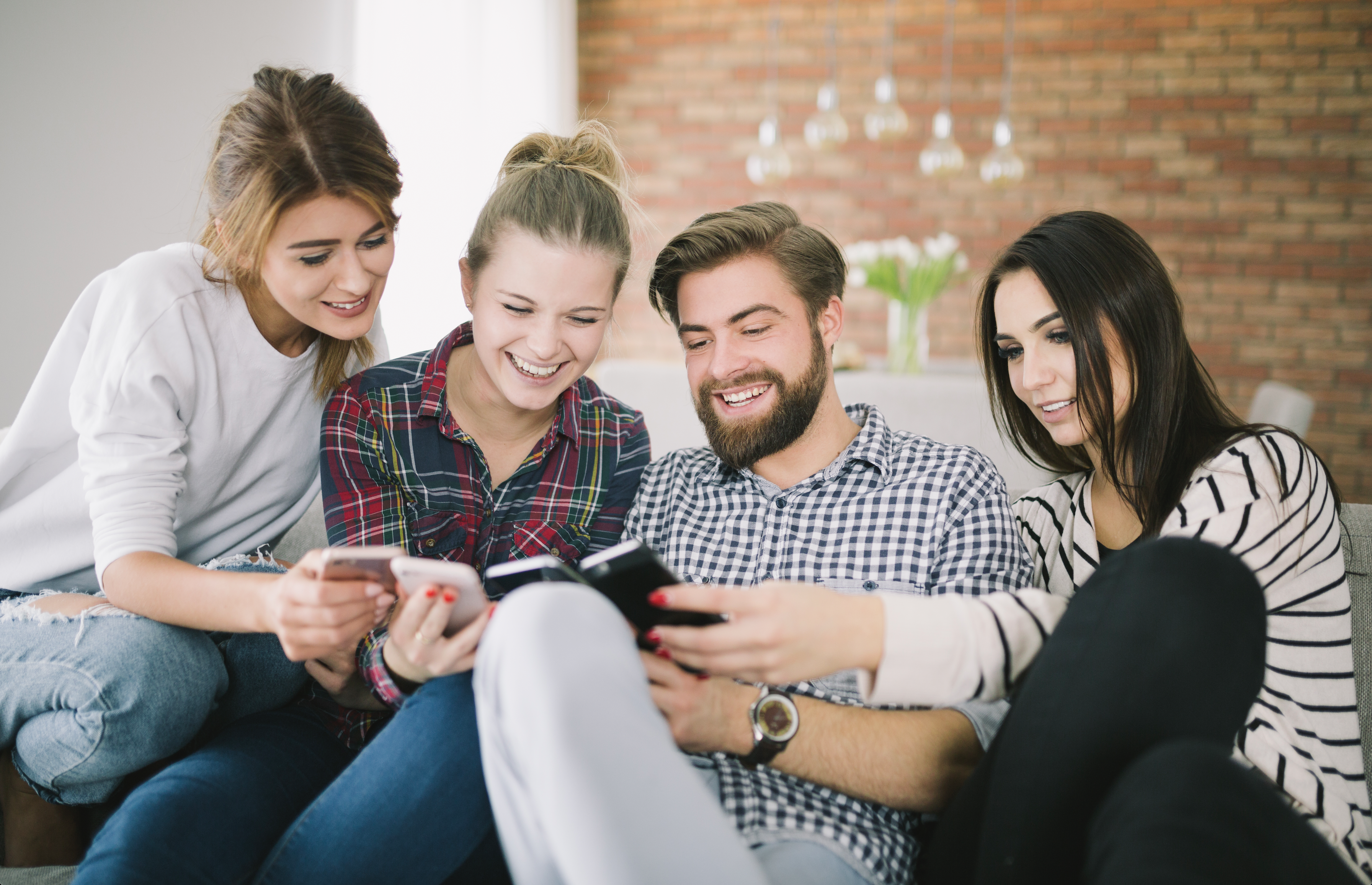 Group of young people using smartphones to manage a community with Resinara